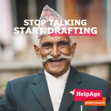 white text reads Stop Talking Stop Drafting above an elder man with olive-skin long white mustache and Nepali topi. The Help Age International logo in the lower right corner